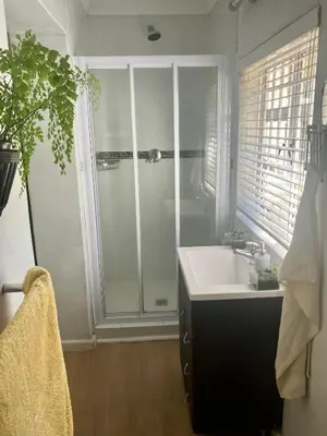 a bathroom with a shower and a white sink at Conde Rest in Stellenbosch