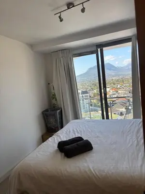 a bedroom with a bed with a large window at A little heaven in Strand