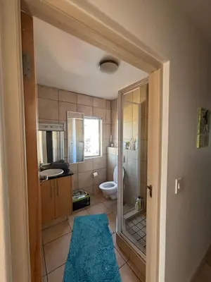 a bathroom with a toilet and a sink and a shower at A little heaven in Strand