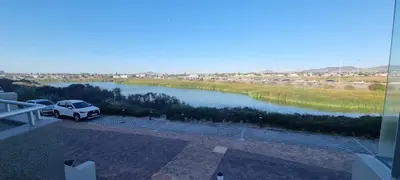 a view of a river from a balcony at 2 Bedroom Apartment - Dolphin Beach in Cape Town
