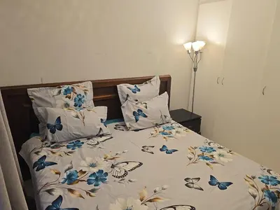 a bedroom with a bed with blue butterflies on it at Blouberg 2 bedroom apartment in Cape Town