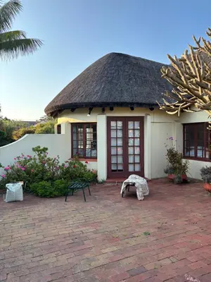 a small white house with a thatched roof at Hermanus Hartshuis in Hermanus