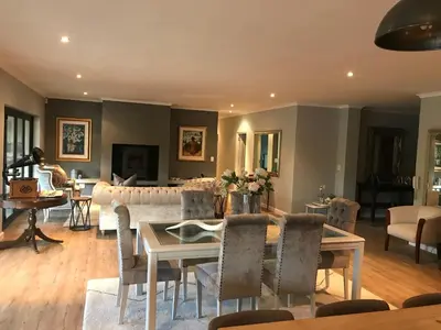 a living room with a couch and a table at 10onErika Franschhoek in Franschhoek