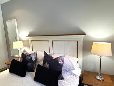 a bedroom with a bed with black and white pillows at 10onErika Franschhoek in Franschhoek
