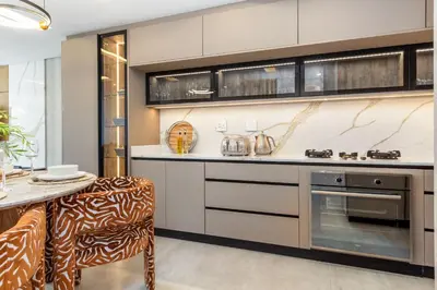 a kitchen with a counter and a table with chairs at Lagoon Beach Luxe 116A in Cape Town