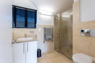 a bathroom with a shower and a sink and a toilet at Luxury Lodge TheView, Pearl Valley Golf Estate in Paarl
