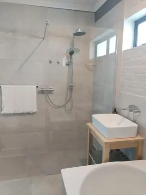 a bathroom with a shower and a sink at Heaven Scent in Bettyʼs Bay