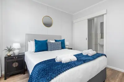 a bedroom with a large bed with towels on it at La Savina The Island Club in Cape Town