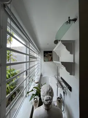a bathroom with a statue in a sink next to a window at Somerset West All Stay 4 in Somerset West