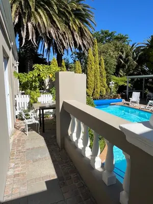 a balcony of a house with a swimming pool at Somerset West All Stay 4 in Somerset West