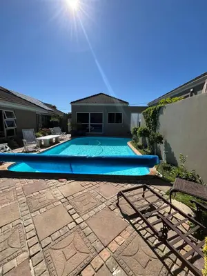 a swimming pool in the backyard of a house at Somerset West All Stay 4 in Somerset West