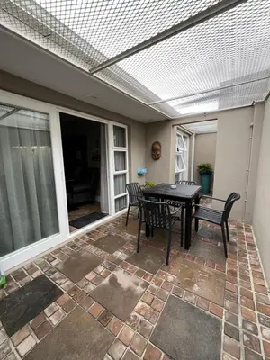 a patio with a table and chairs and a ceiling at Somerset West All Stay 4 in Somerset West