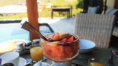 a bowl of fruit sitting on top of a table at 43 On Sandstone in Somerset West