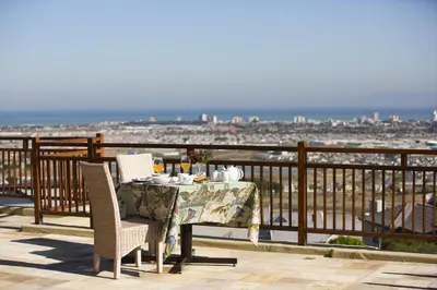 a table and chairs on a balcony with a view at 43 On Sandstone in Somerset West