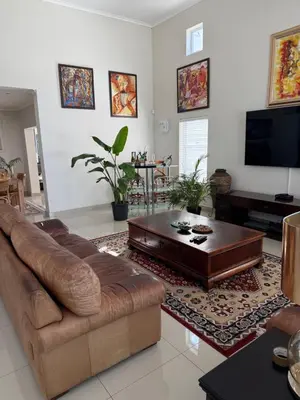 a living room with a couch and a coffee table at Parklands Family Stay in Cape Town