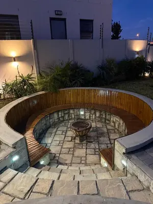 a fire pit in the middle of a patio at Parklands Family Stay in Cape Town