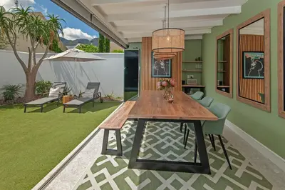 a dining room with a wooden table and chairs at Luxury Villa in Best Central Location in Franschhoek