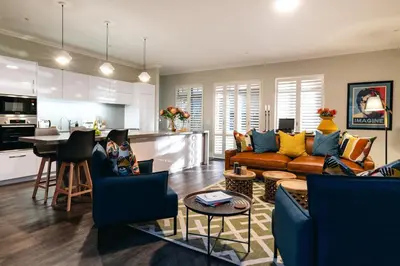 a living room with a couch and a kitchen at Luxury Villa in Best Central Location in Franschhoek