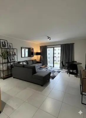 a living room with a couch and a table at Cosy spot in Blackheath