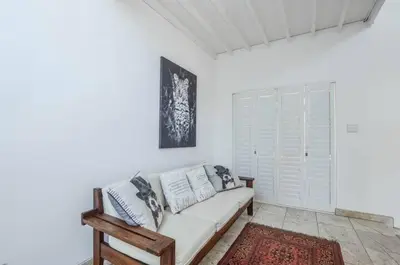 a white couch in a white room with a rug at Large 4 Bedroom Villa with Pool in Cape Town