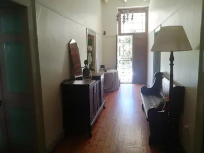 a living room with a television and a couch at House On Plein in Paarl
