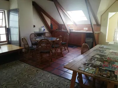 a dining room with a table and chairs at House On Plein in Paarl