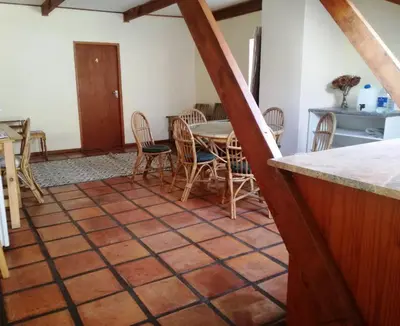 a kitchen and dining room with a table and chairs at House On Plein in Paarl