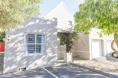 a white house with a tree in front of it at Home in Durbanville in Oakdale