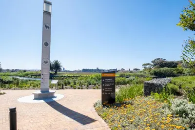 a sign in front of a monument in a garden at 413 Riverlands - 1 Bedroom Apartment with Parking in Cape Town