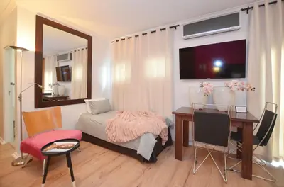 a bedroom with a desk and a bed and a table at The Sleep Easy in the Old Town Stellenbosch in Stellenbosch