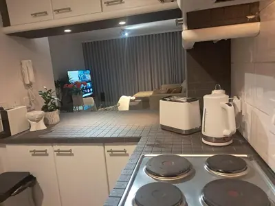 a kitchen with a stove top in a room at Salt & Sandy Shores Dolphin Beach Blouberg in Cape Town