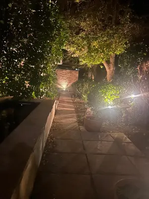 a walkway at night with two lights on at Bishopsfield Guesthouse Rondebosch in Cape Town