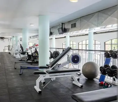 a gym with a row of treadms and weights at Nice Views in Cape Town