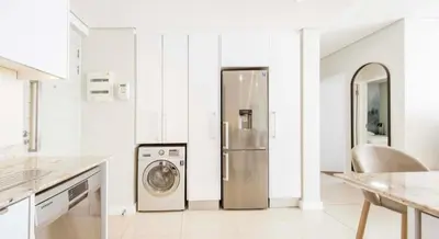 a kitchen with a refrigerator and a washing machine at Andringa Walk, Modern 2 Bedroom Apartment in Stellenbosch