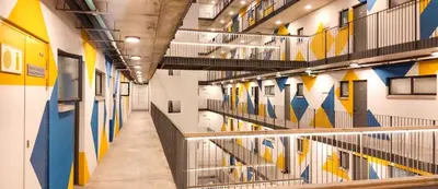 a hallway in a building with colorful walls and stairs at The Hideaway on Moringa Way in Cape Town