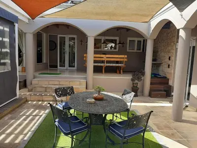 a patio with a table and chairs on a patio at Simply The Choice Manor in Cape Town