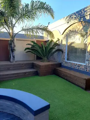 a backyard with a patio with green grass at Simply The Choice Manor in Cape Town
