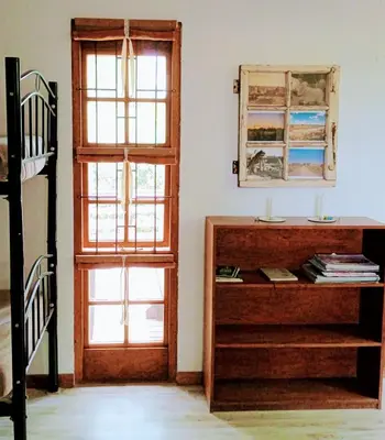 a room with a wooden door and a dresser at Groendraai PetFriendly SelfCatering Accommodation, Die Karoohuis, Die Wijnhuis and Die Vinknes