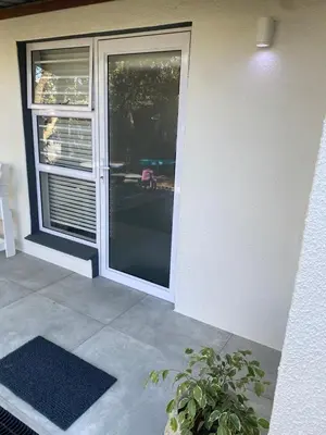 an open door to a patio with a potted plant at Garden flat Durbanville - with Office, WiFi and secure gated parking in Eversdal