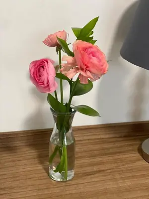 a vase filled with pink flowers on a table at Garden flat Durbanville - with Office, WiFi and secure gated parking in Eversdal