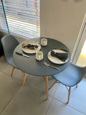 a table with two chairs and a plate of food on it at Garden flat Durbanville - with Office, WiFi and secure gated parking in Eversdal