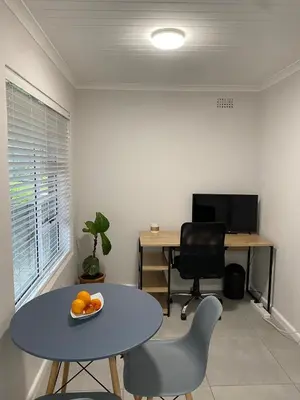 an office with a table and chairs and a desk at Garden flat Durbanville - with Office, WiFi and secure gated parking in Eversdal