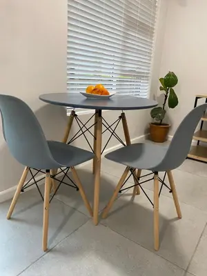 a table with two chairs and a plate of oranges on it at Garden flat Durbanville - with Office, WiFi and secure gated parking in Eversdal