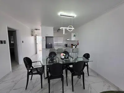 a dining room with a glass table and black chairs at 607 Odean - Luxury Ocean Escape in Strand