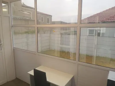 an empty office with a desk and a window at Cosy 3 bedroom in Cape Town