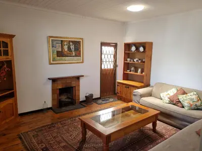 a living room with a couch and a fireplace at 3 On Herschell in Strand