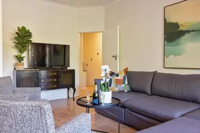 a living room with a couch and a tv at The Ya Ya Apartment in Stellenbosch