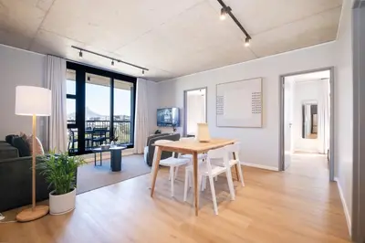 a living room with a table and a couch at 504 Riverlands - Lux 2 Bedroom Apartment with Parking in Cape Town