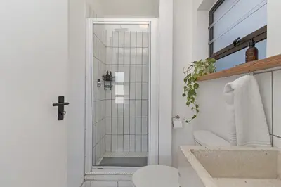 a bathroom with a shower with a toilet and a sink at San Norina Gardens 5 in Cape Town