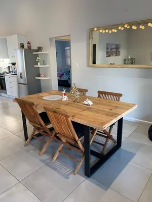 a wooden table in a kitchen with chairs around it at Columbus Haven in Hermanus